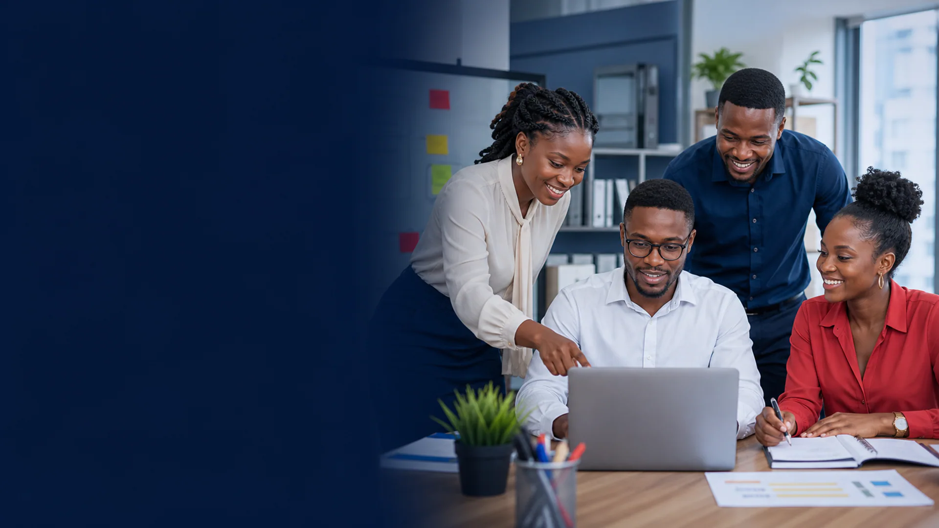A professional team collaborating around a laptop