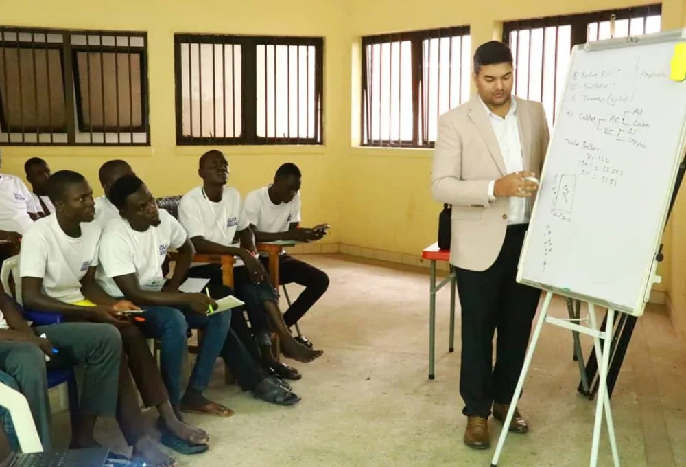 Instructor explaining solar electrical concepts to participants